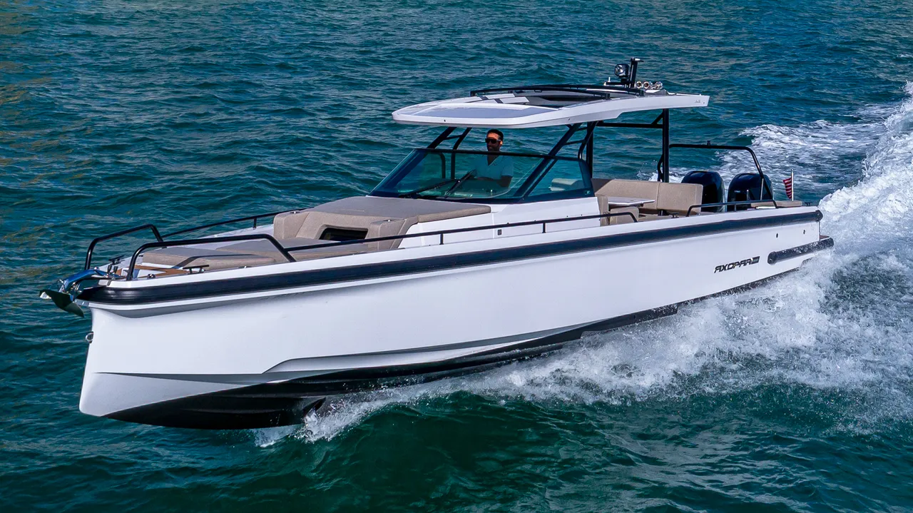 A boat anchored at one of the best sandbars in Miami in shallow turquoise water
